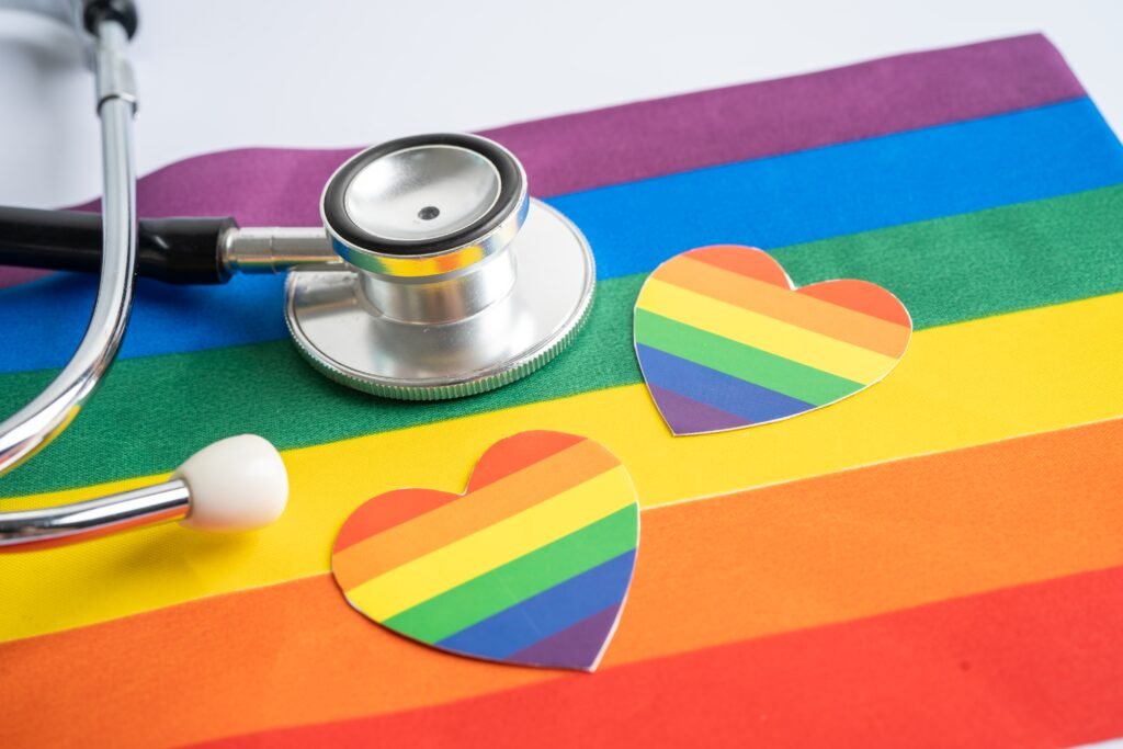 Black stethoscope with heart on rainbow flag background, symbol
